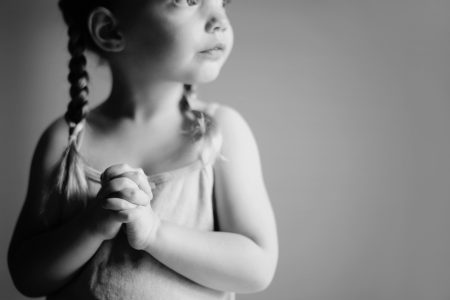 Child hands folded in prayer
